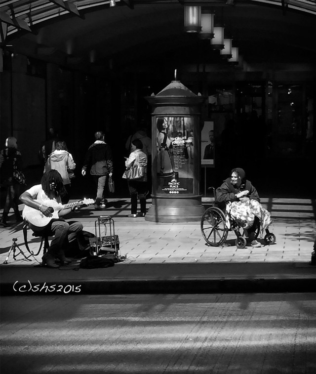 Susan Nolen's Photograph of the homeless in Seattle enjoying the music of a busker